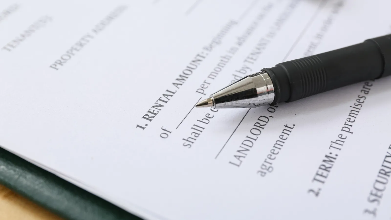 Pen resting on a rental agreement form
